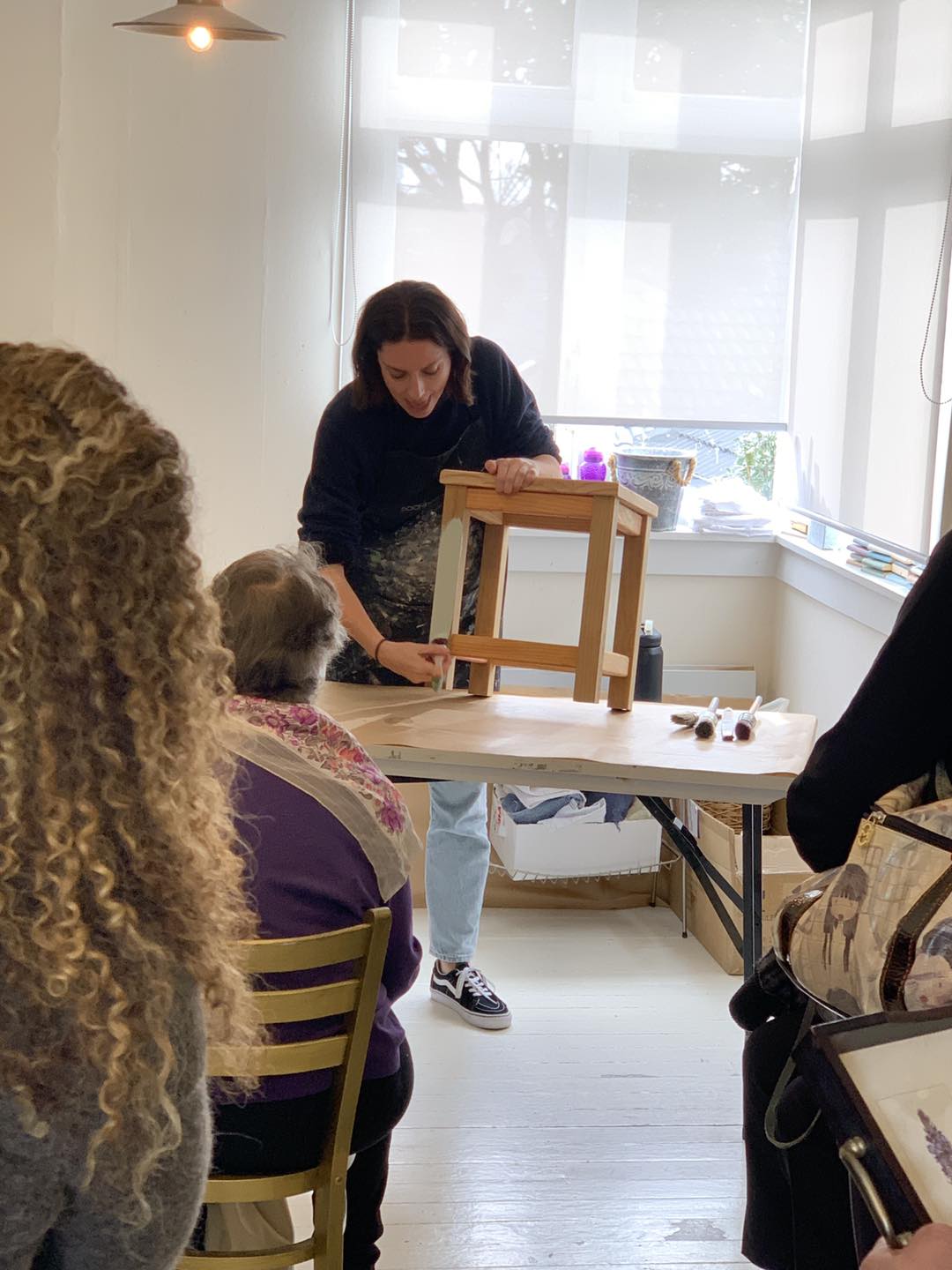 Demonstrating painting a wooden chair 