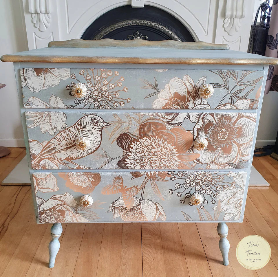 Set of Drawers painted in the French Chateau methode with Bach Blue chalk paint and the front is decoupaged with Foil Birds decoupage paper, a floral and bird design in gold and brown on a blue background.