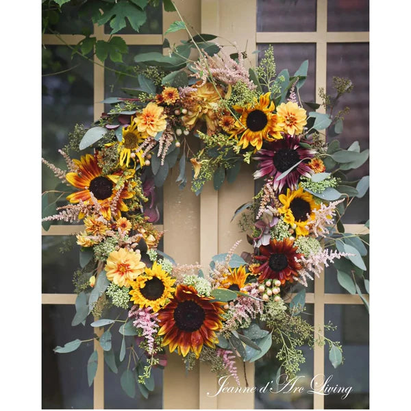 Decorative wreath with sunflowers and greenery on a door