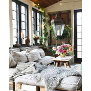 Cozy living room with a sofa, decorative pillows, and a hanging lantern.