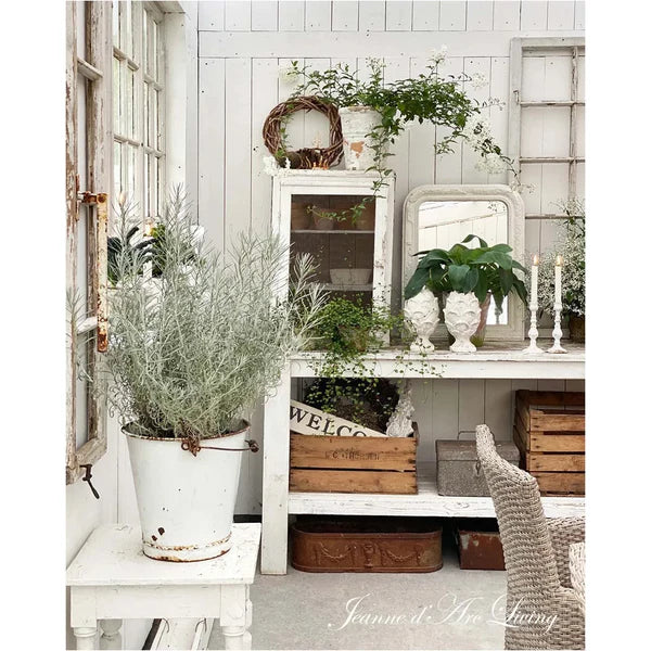 Vintage-style interior with plants, wooden crates, and a 'Welcome' sign.