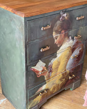 Young Girl Reading Chest of Drawers